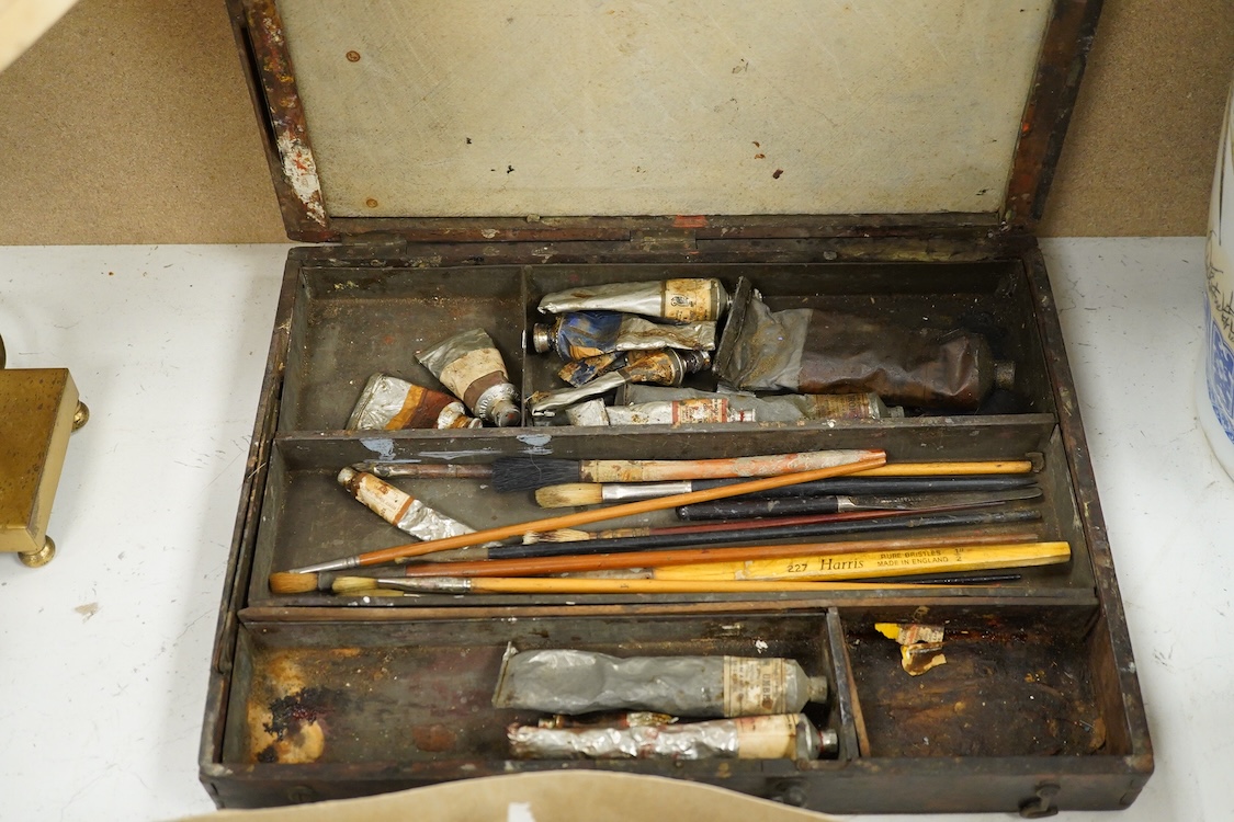Three early to mid 20th century artist’s paint boxes, one tin box with Winsor and Newton label to the inside of the lid, plus a Rowley labelled box, a wooden paint box- 39cm wide, together with a leather pencil case, the